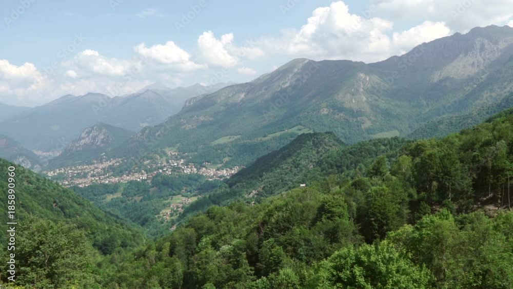 Beautiful and stunning view of mountains, mountainsides and woods, white clouds far away. Beautiful and stunning view of mountains, mountainsides and woods, white clouds far away.
