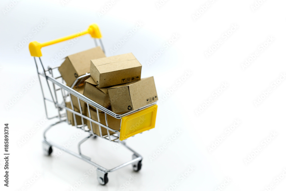 Business: paper box in shopping cart  with copy space using as background marketing, business online concept.