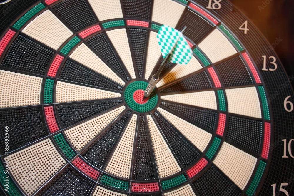 Success hitting target aim goal achievement concept background - three darts in bull's eye close up Success hitting target aim goal achievement concept background - three darts in bull's eye close up