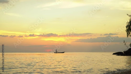 Boat on open sea sunset horizon. Beautiful yellow decline on the ocean horizon. Ph Qu c Island. A silhouette of the small boat with the fisherman