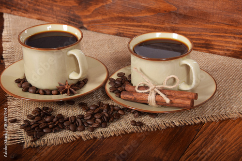 black sweet coffee in brown cups with vanilla cane and anise flower with free space for text