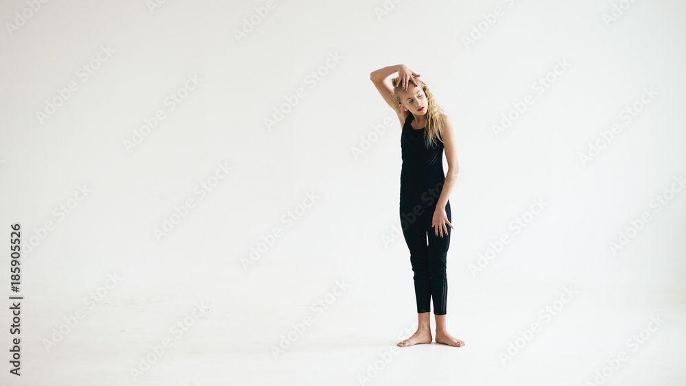 Modern beautiful teenage girl dancer dancing contemporary on white background indoors Modern beautiful teenage girl dancer dancing contemporary on white background indoors