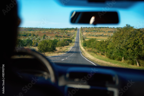 The view from inside the moving car is sent along a two-lane road, the territory of Moldova. photo
