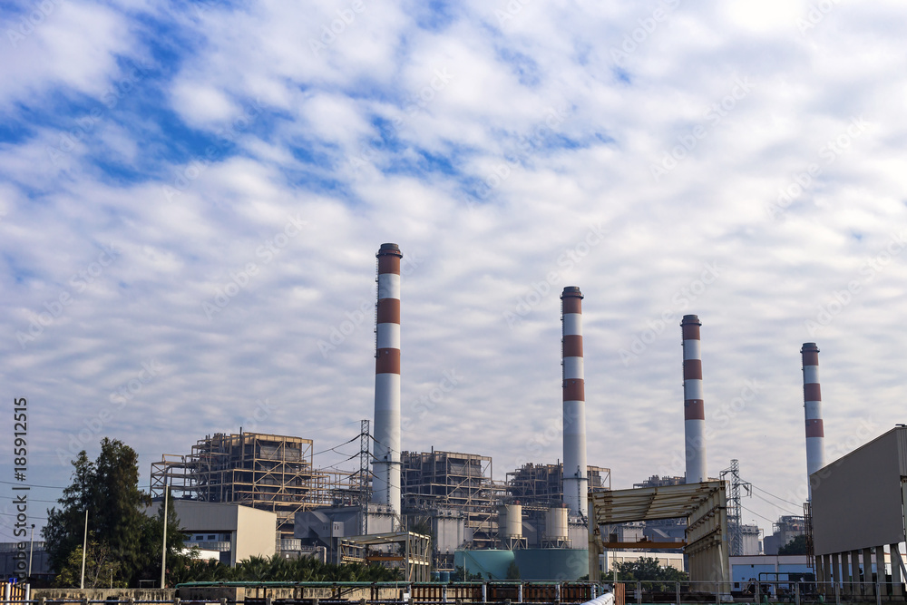 Power plant in the morning light with clouds sky background.