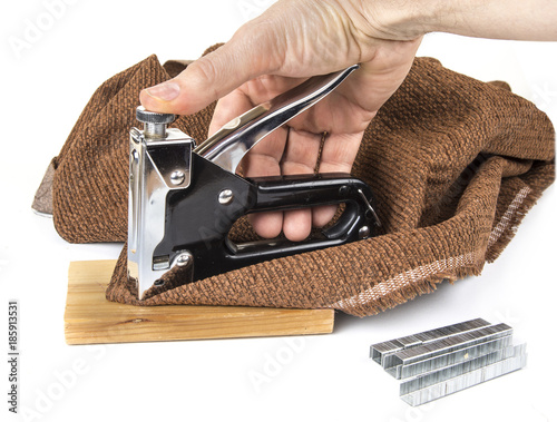 Heavy duty staple gun with staples on the white background photo