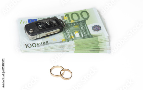 Gold digger concept. Money, car and wedding rings. photo