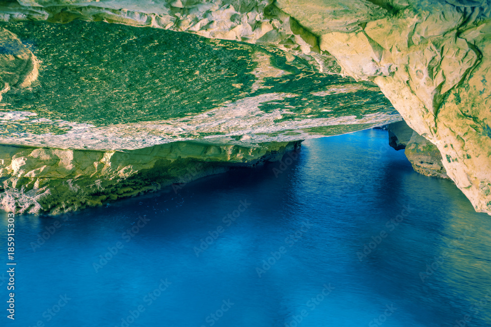 Natural grottoes in cave with calm sea, Israel