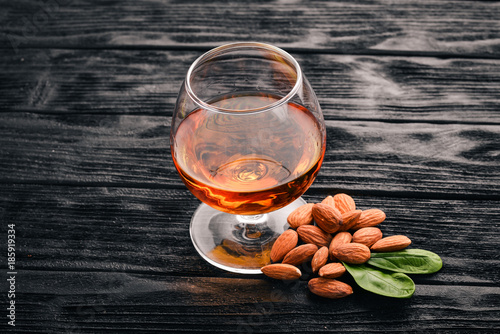 Amaretto Almond Liquor. Almond On a wooden background. Italian drink Top view. Free space for text. photo