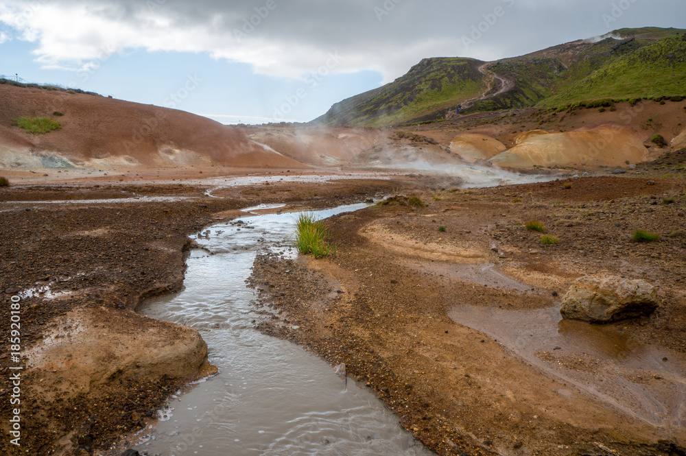 Geothermal fields of Krysuvik with river and mountains in the background