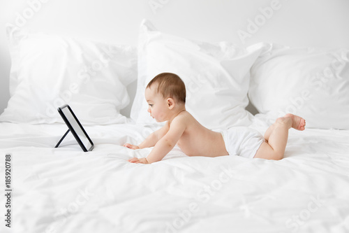 Baby lying on tummy facing a mirror