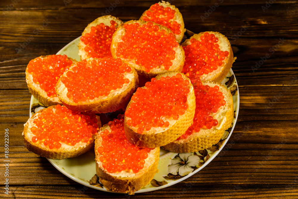 Sandwiches with red caviar on wooden table. Top view Sandwiches with red caviar on wooden table. Top view