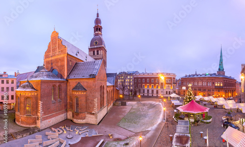 Decorated and illuminated Christmas tree, Christmas Market and the Cathedral of Saint Mary at Cathedral Square, Doma laukums, Riga, Latvia. Aerial panoramic view
