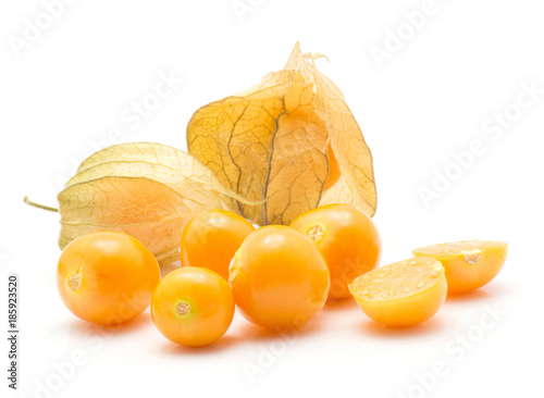 Physalis berries stack isolated on white background two in husk a lot of orange berries one sliced. photo