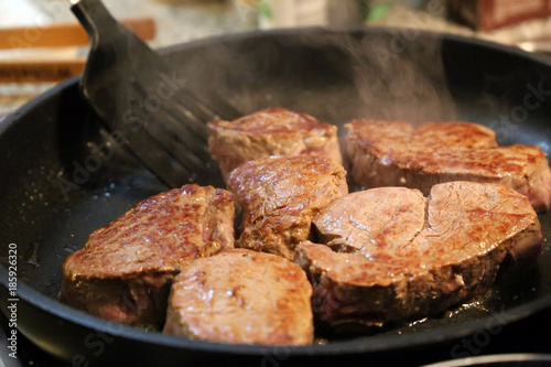 Beef fillet (beef tenderloin) grilling in the frying pan