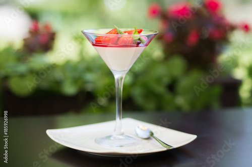 Strawberry panna cota in a martini glass photo