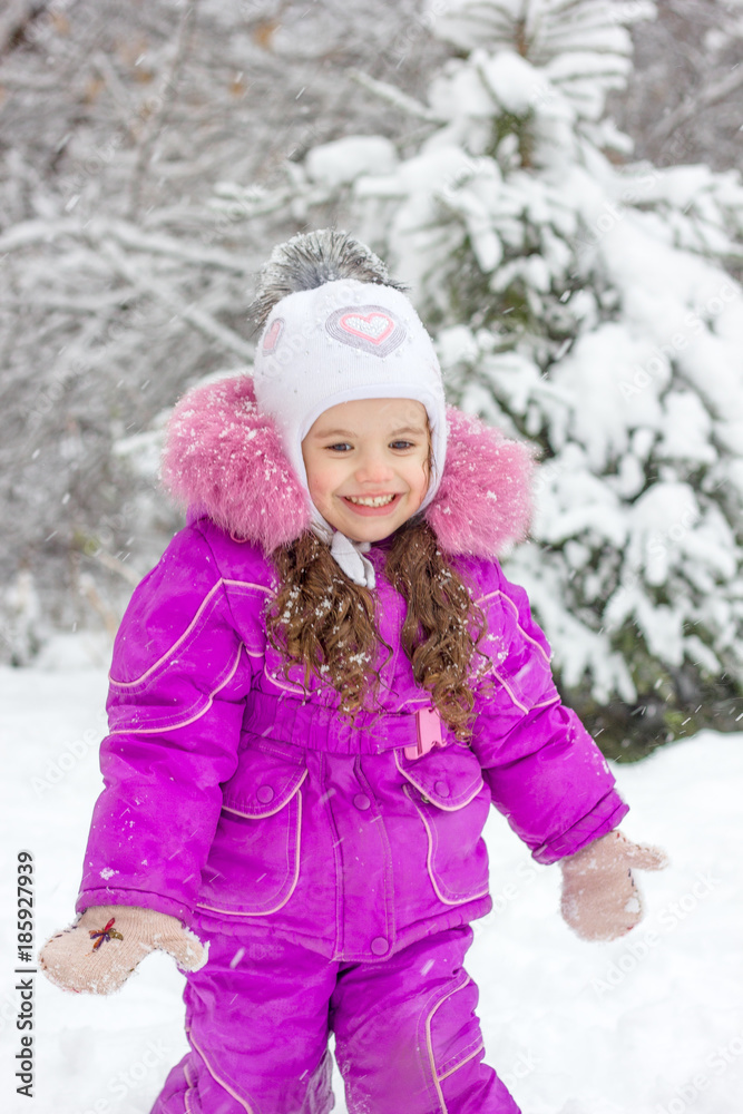 Little girl having fun on snowy winter day outdoors. Little girl having fun on snowy winter day outdoors.