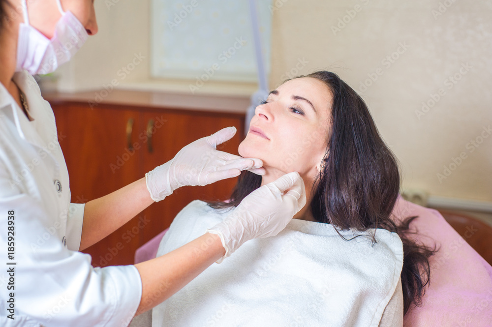A girl at a doctor's appointment, a cosmetologist, a dermatologist, a dentist or a plastic surgeon A girl at a doctor's appointment, a cosmetologist, a dermatologist, a dentist or a plastic surgeon