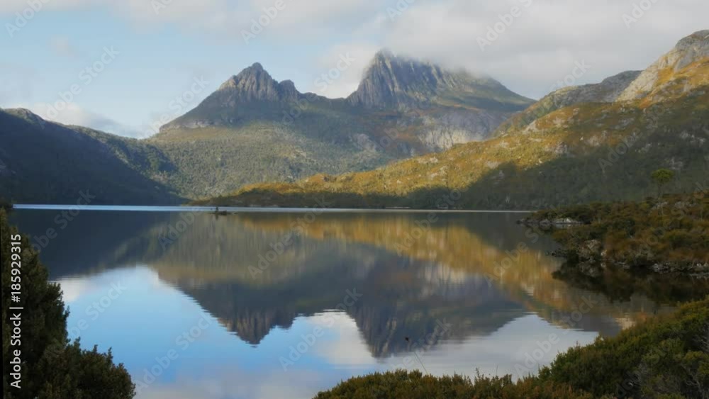 morning shot of cradle mountain reflected on a calm dove lake in tasmania, australia