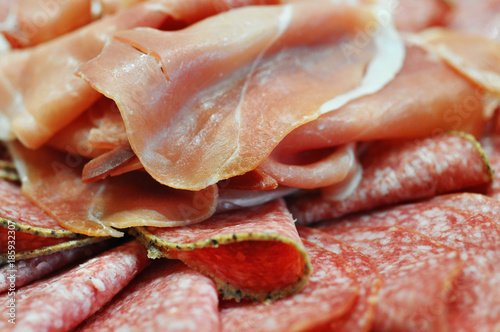 Close-up of meat plate with sliced salami and jamon