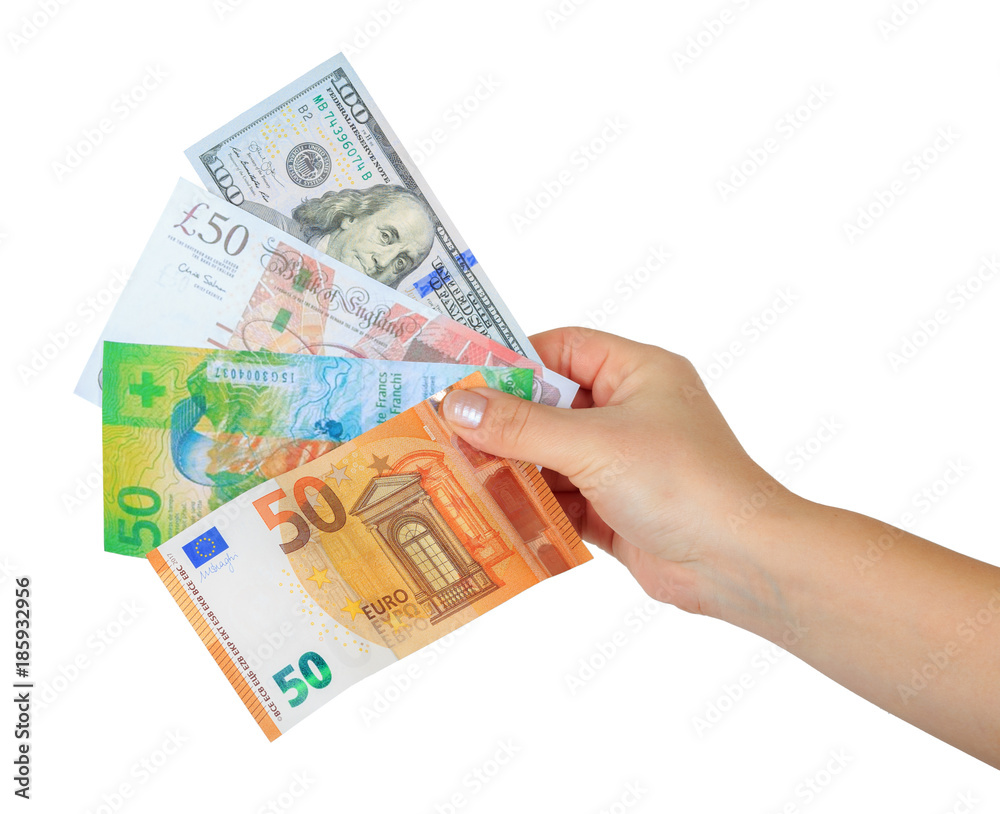 women's hand holding a money fan with four currencies