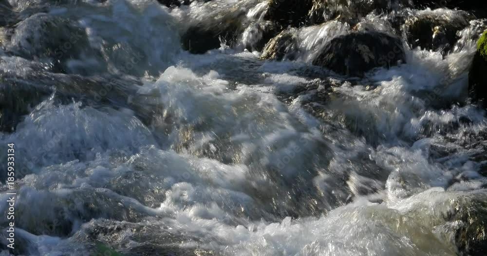 Close up of water stream with white and transparent bubbles. Close up of water stream with white and transparent bubbles.