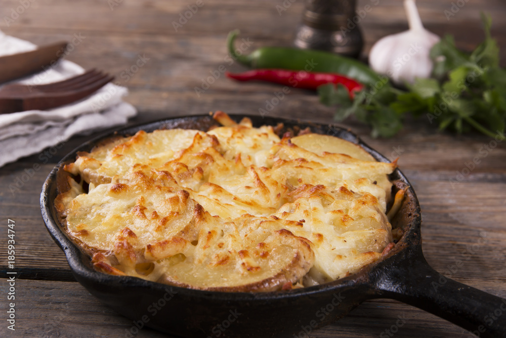 potato casserole with cheese in a frying pan serving vegetarian dish homemade potato casserole with cheese in a frying pan serving vegetarian dish homemade