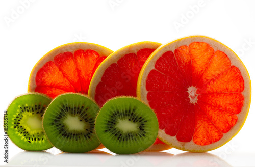 Fresh ripe juicy and appetizing grapefruit with kiwi and their parts close-up, isolated on white background.