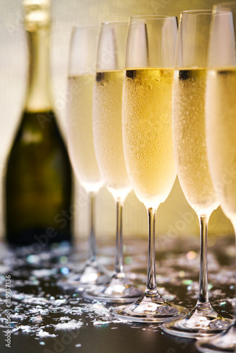 Many glasses of champagne in a line. Selective focus