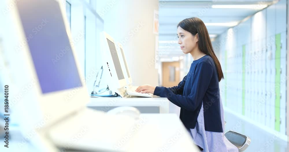 Student using computer inside university campus Student using computer inside university campus