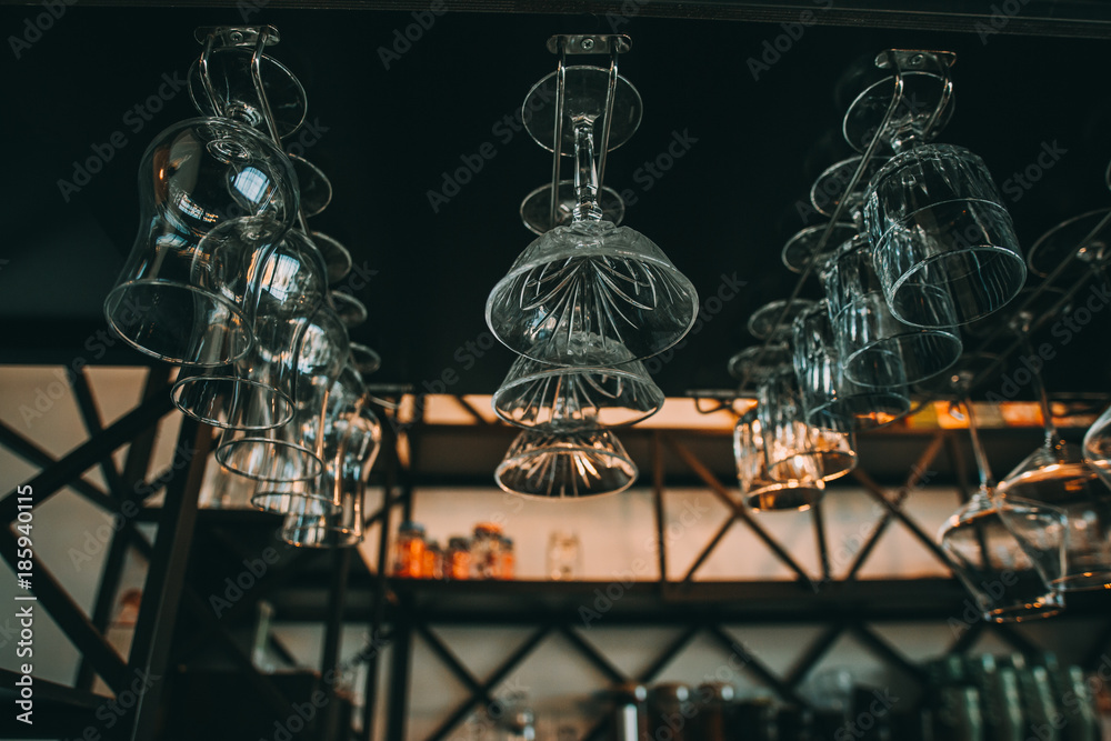 Empty glasses for wine above a bar rack in vintage