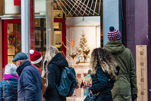 Tourists paying attention to decorated showcase of an art shop photo