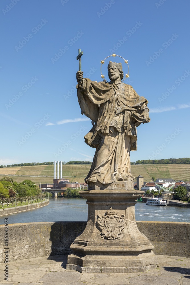 Baroque Statue of Saint John of Nepomuk, designed in the 18th century, Wurzburg, Franconia, Bavaria, Germany. This sculpture is standing at the old bridge over the River Main
