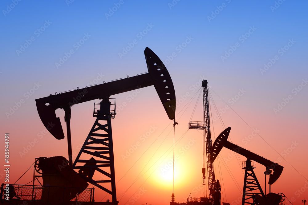 Is operation of pumping unit, sunset in oil field Is operation of pumping unit, sunset in oil field