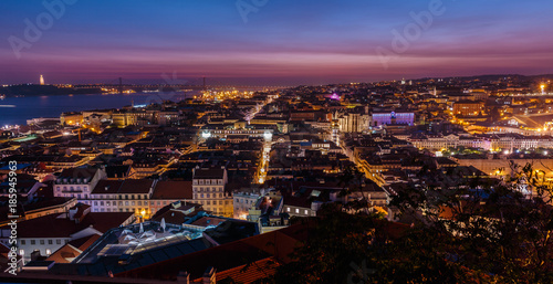 Spectacular night view of Lisbon  Portugal overseeing the entire downtown  the Tagus river  the Cristo Rei - Sanctuary of Christ the King - and the Ponte 25 de Abril suspension bridge 