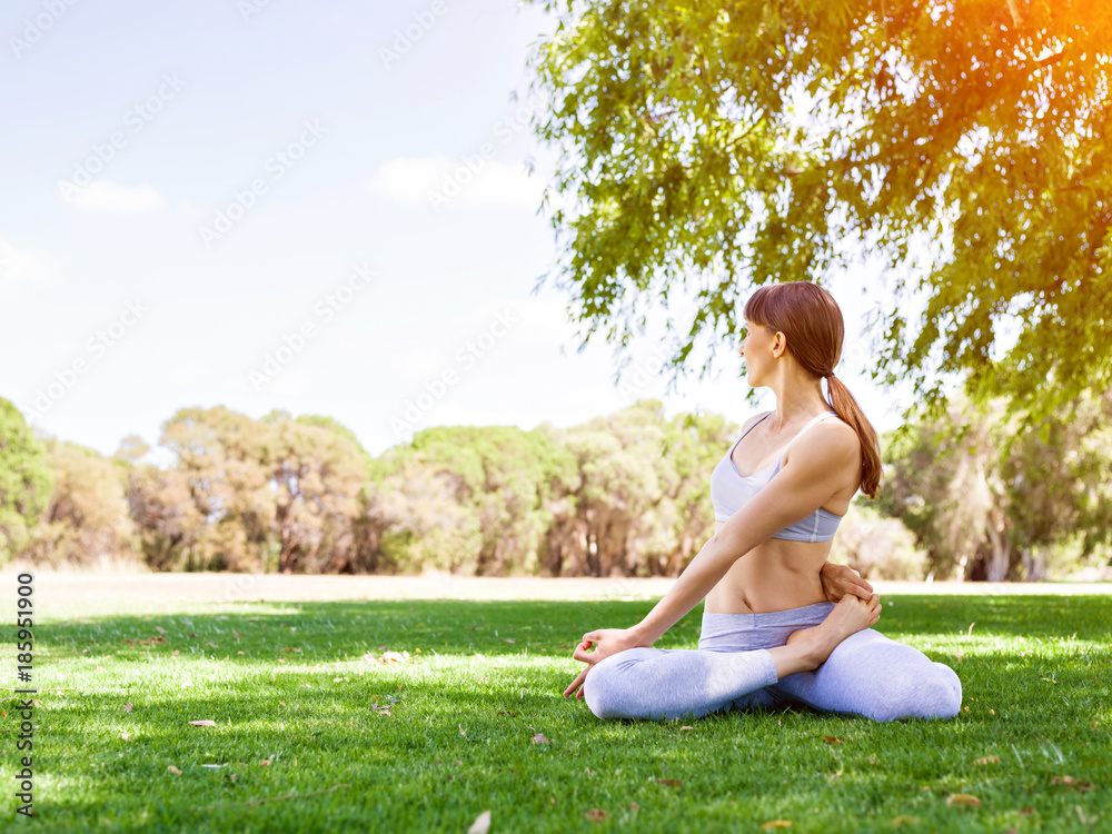 Young woman practicing yoga in the park Young woman practicing yoga in the park