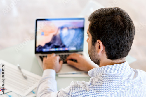 Handsome businessman working at computer