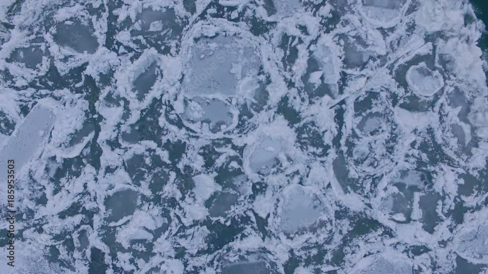 AERIAL: A view from above of a huge ice floe on the river during an ice drift. Beautiful ice pattern. AERIAL: A view from above of a huge ice floe on the river during an ice drift. Beautiful ice pattern.