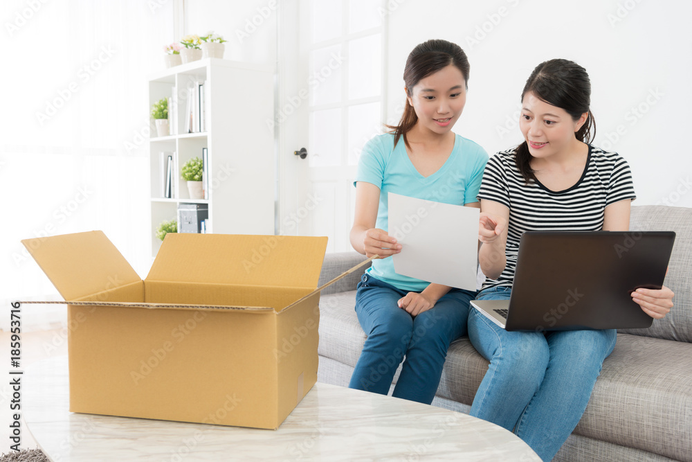 sisters looking at online shopping parcel list sisters looking at online shopping parcel list