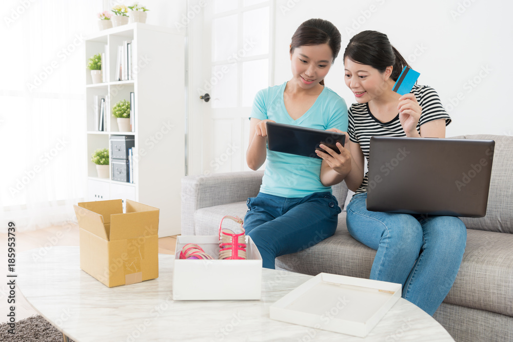 beautiful young sisters looking at mobile pad beautiful young sisters looking at mobile pad