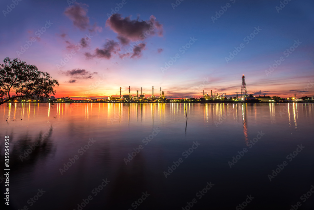 Oil and gas industry - refinery at Sunrise - factory - petrochemical plant with reflection over the river