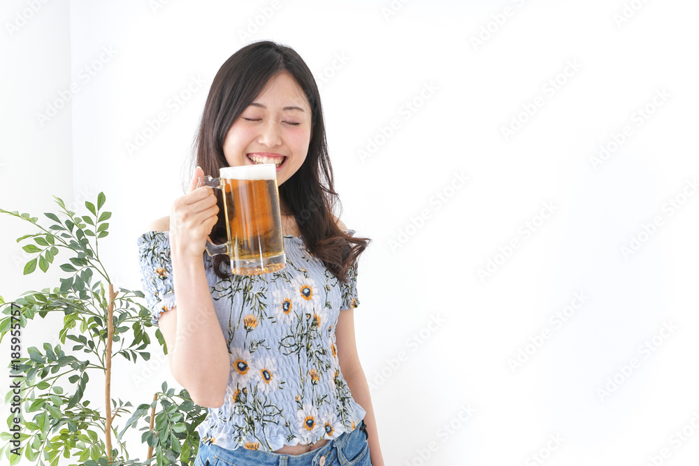 Young woman cracking a beer in beer garden Young woman cracking a beer in beer garden