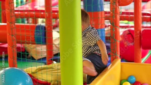 Portrait of little boy in shorts and shirt playing on the Playground. Little boy playing on a colorful Playground. photo