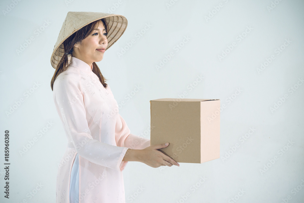 beautiful woman in pink dress and vietnam hat holding box beautiful woman in pink dress and vietnam hat holding box