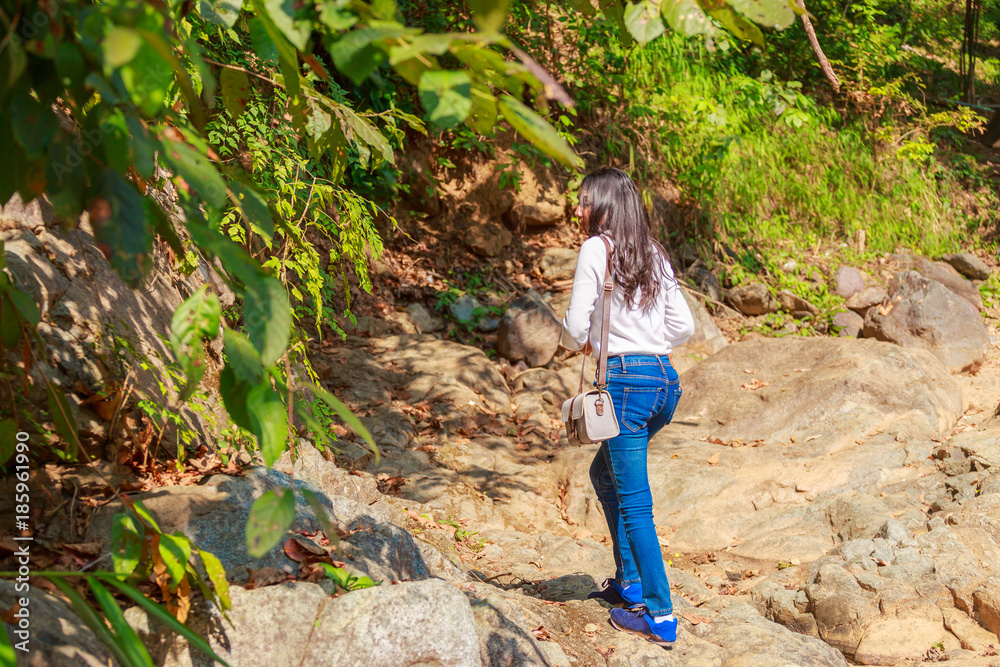 Naklejka premium Woman hiking around mountains near the river at spring time.