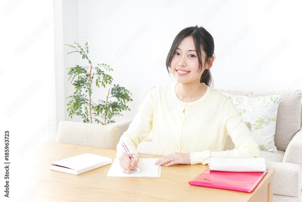 Female student studying for an entrance exam at home Female student studying for an entrance exam at home