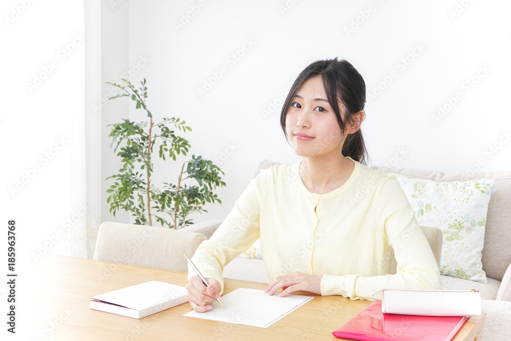 Female student studying for an entrance exam at home Female student studying for an entrance exam at home