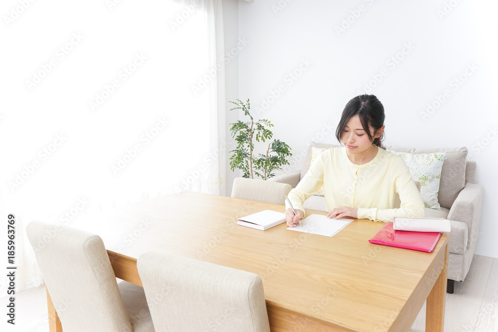 Female student studying for an entrance exam at home Female student studying for an entrance exam at home