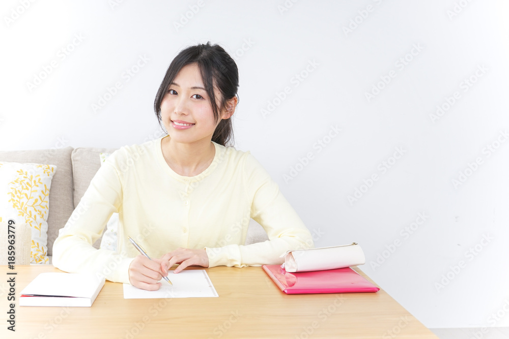 Female student studying for an entrance exam at home Female student studying for an entrance exam at home