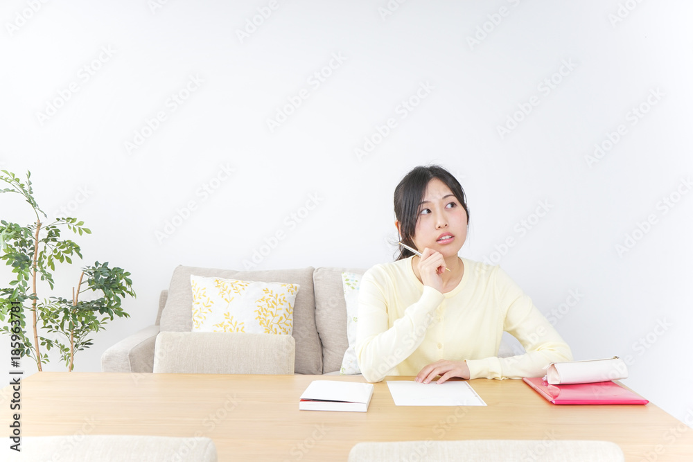 Female student studying for an entrance exam at home Female student studying for an entrance exam at home