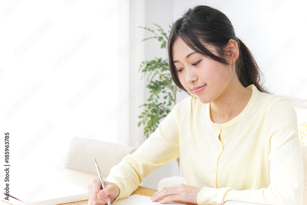 Female student studying for an entrance exam at home Female student studying for an entrance exam at home